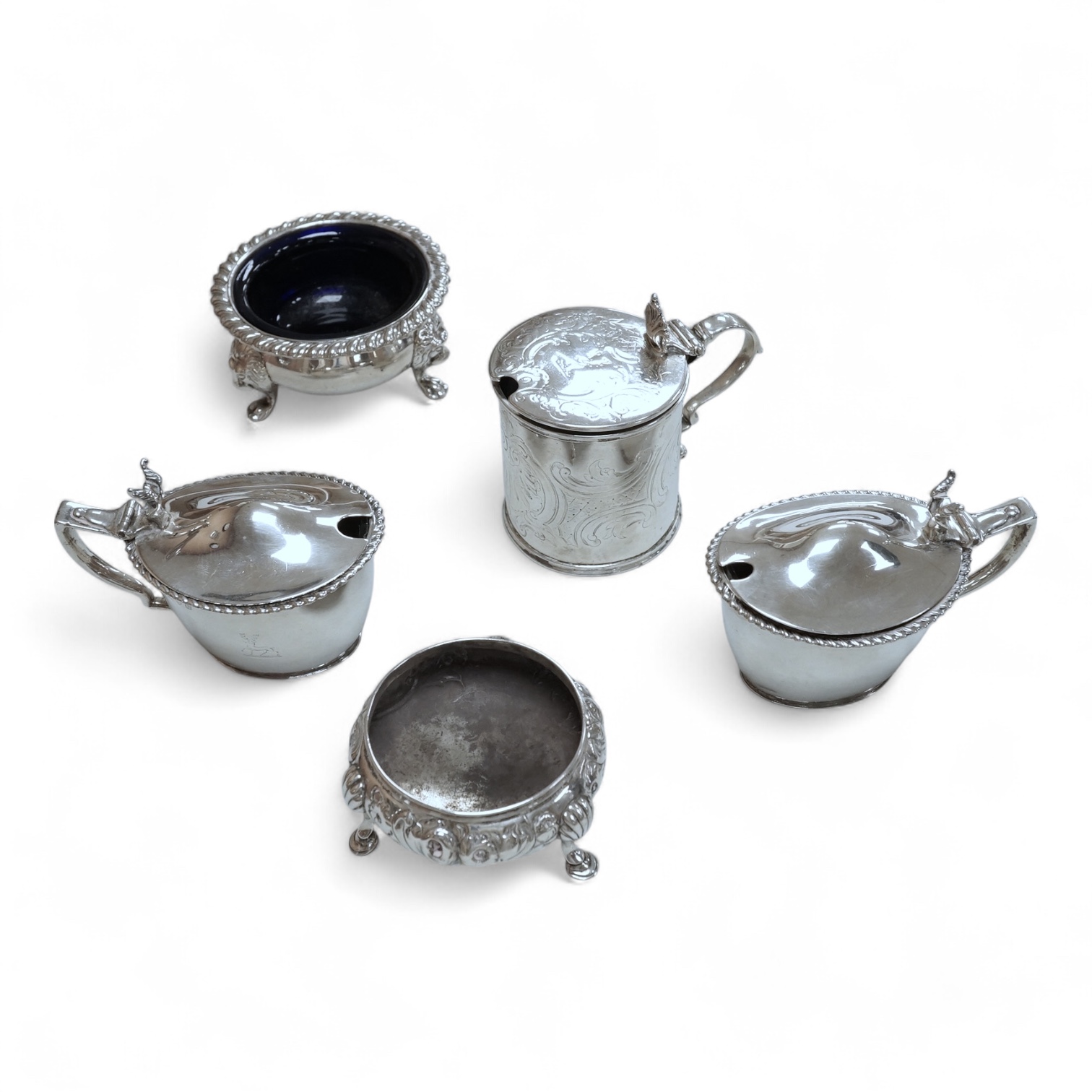 A Victorian silver drum mustard pot, a pair of later silver mustard pots and two silver salts including Victorian.